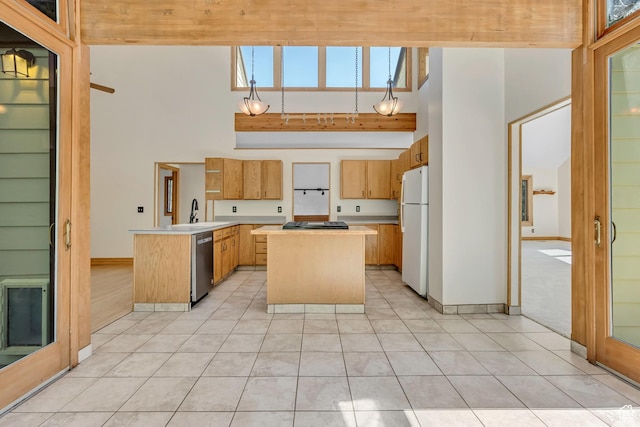 3697 Wagon Wheel Way, Park City, UT 84098 - kitchen with freestanding refrigerator, stainless steel dishwasher, a peninsula, light countertops, and a towering ceiling