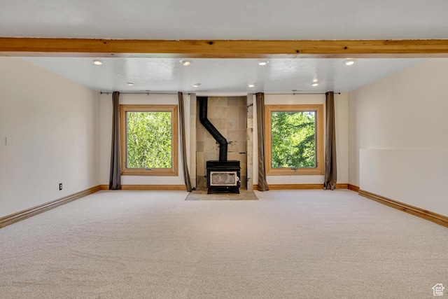 3697 Wagon Wheel Way, Park City, UT 84098 - unfurnished living room featuring a wood stove, recessed lighting, carpet floors, plenty of natural light, and beamed ceiling