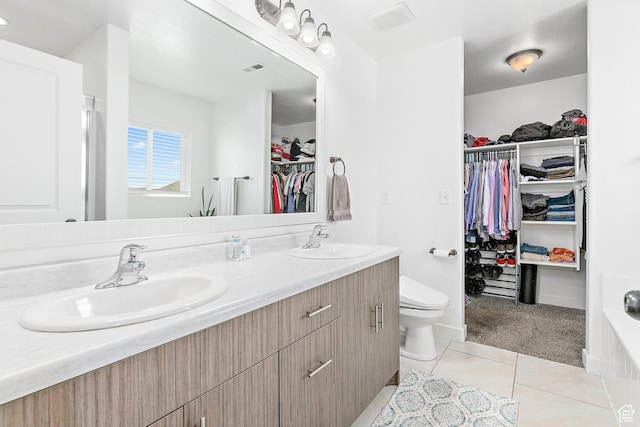 4857 N Goosefoot Dr, Eagle Mountain, UT 84005 - bathroom featuring a walk in closet, double vanity, and tile patterned flooring