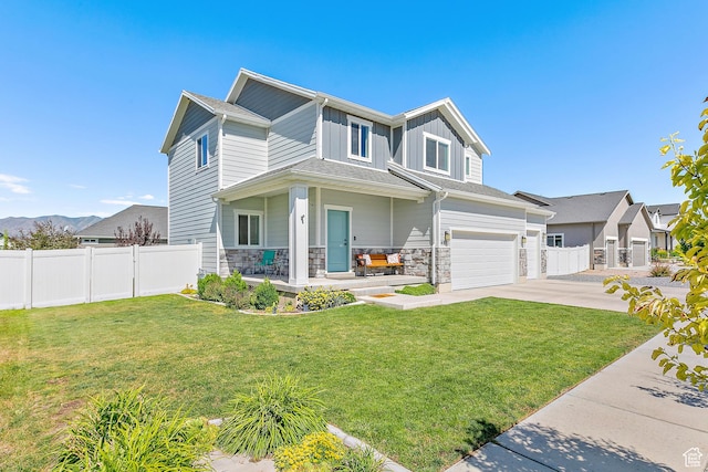 4857 N Goosefoot Dr, Eagle Mountain, UT 84005 - view of front of property featuring board and batten siding, a garage, driveway, a porch, and stone siding