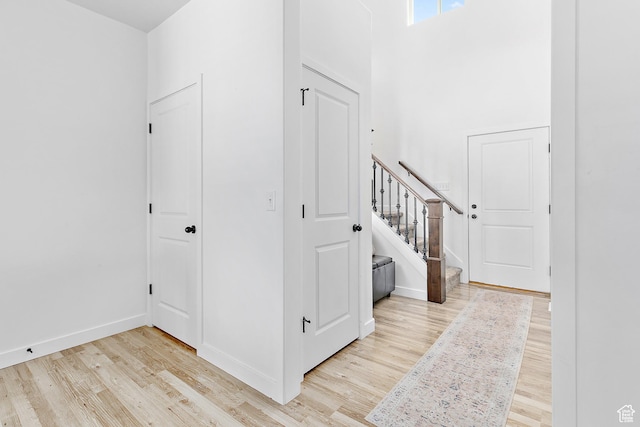 4857 N Goosefoot Dr, Eagle Mountain, UT 84005 - foyer entrance with wood finished floors, stairs, and a towering ceiling