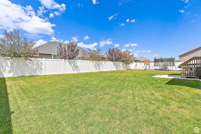 4857 N Goosefoot Dr, Eagle Mountain, UT 84005 - fenced backyard featuring a playground and a trampoline