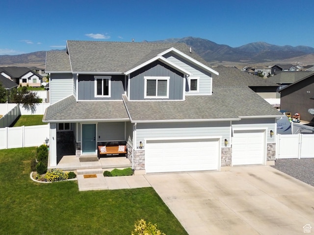 4857 N Goosefoot Dr, Eagle Mountain, UT 84005 - craftsman house featuring covered porch, a shingled roof, a mountain view, and stone siding