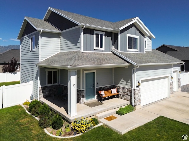 4857 N Goosefoot Dr, Eagle Mountain, UT 84005 - craftsman house with a porch, driveway, stone siding, a shingled roof, and board and batten siding