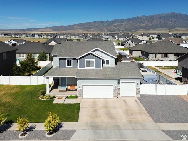 4857 N Goosefoot Dr, Eagle Mountain, UT 84005 - view of front facade featuring a residential view, stone siding, concrete driveway, a garage, and a mountain view