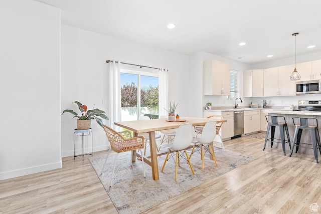 4857 N Goosefoot Dr, Eagle Mountain, UT 84005 - dining area featuring light wood finished floors, recessed lighting, and healthy amount of natural light