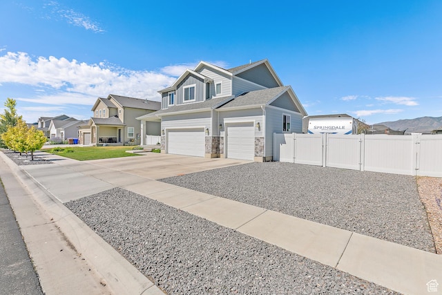 4857 N Goosefoot Dr, Eagle Mountain, UT 84005 - view of front of home with a residential view, concrete driveway, a gate, a garage, and stone siding