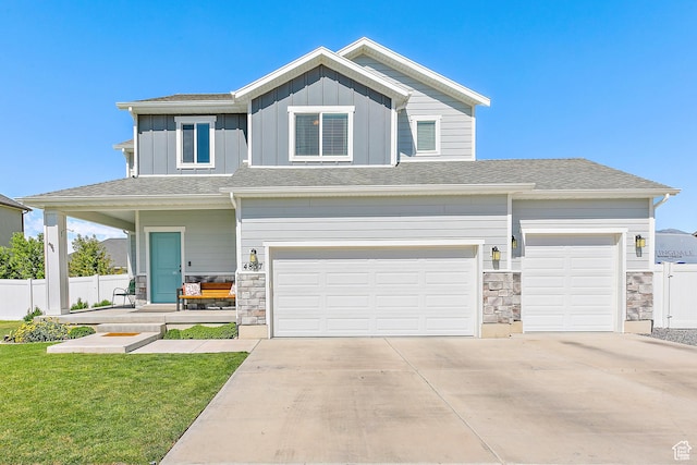 4857 N Goosefoot Dr, Eagle Mountain, UT 84005 - view of front of home featuring stone siding, concrete driveway, board and batten siding, and an attached garage
