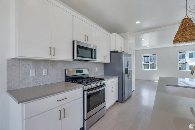753 W Crystal Creek Rd, American Fork, UT 84003 - kitchen with stainless steel appliances, white cabinetry, decorative backsplash, light wood-style flooring, and recessed lighting