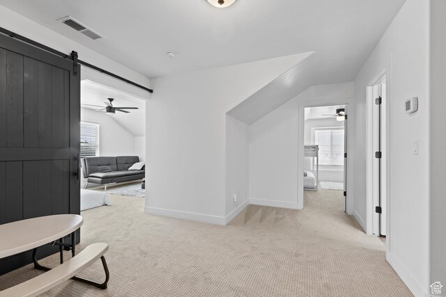 4323 W 2650th Cir S, Hurricane, UT 84737 - hallway featuring light colored carpet, a barn door, and healthy amount of natural light