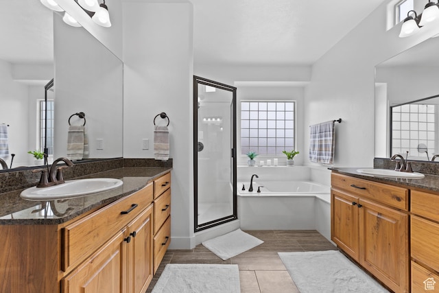 4323 W 2650th Cir S, Hurricane, UT 84737 - full bathroom featuring two vanities, a stall shower, a garden tub, and tile patterned floors