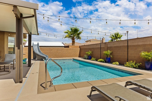 4323 W 2650th Cir S, Hurricane, UT 84737 - view of swimming pool featuring a water slide, a fenced backyard, and a patio