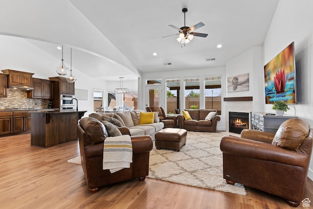4323 W 2650th Cir S, Hurricane, UT 84737 - living room with ceiling fan, light wood-style floors, arched walkways, a tile fireplace, and recessed lighting