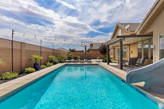 4323 W 2650th Cir S, Hurricane, UT 84737 - view of swimming pool with a water slide, a patio area, and a fenced backyard