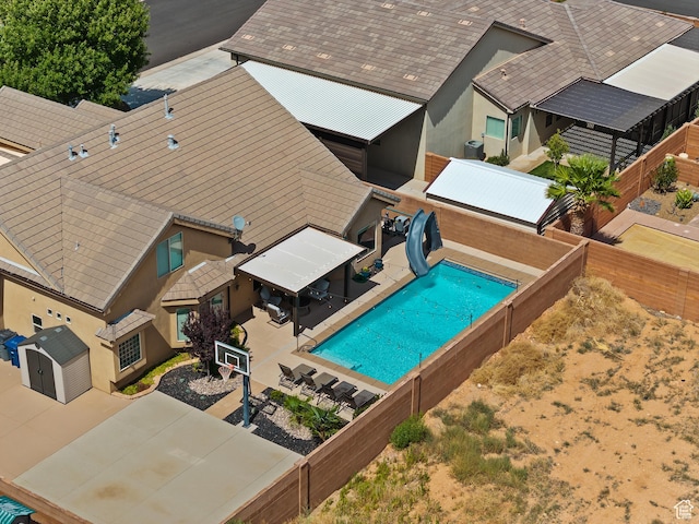 4323 W 2650th Cir S, Hurricane, UT 84737 - view of pool with a water slide, a patio area, a storage unit, and a fenced backyard