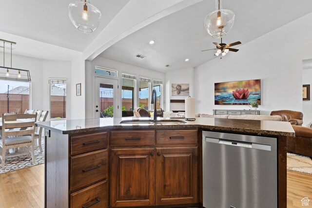 4323 W 2650th Cir S, Hurricane, UT 84737 - kitchen featuring stainless steel dishwasher, open floor plan, dark stone countertops, light wood-style flooring, and healthy amount of natural light