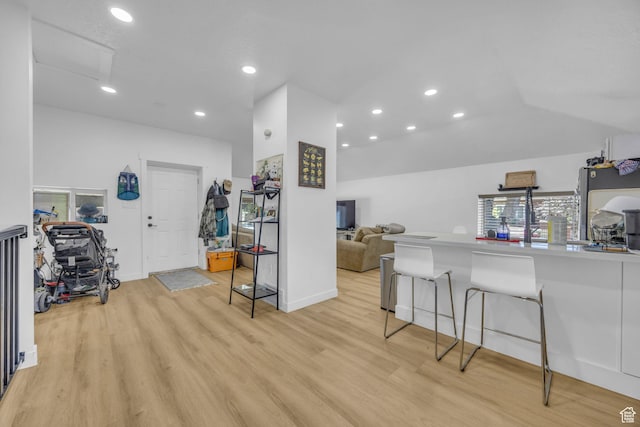 450 E 32 S, Ogden, UT 84401 - kitchen with light wood-style floors, a kitchen breakfast bar, recessed lighting, vaulted ceiling, and open floor plan
