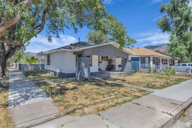 450 E 32 S, Ogden, UT 84401 - ranch-style house featuring covered porch, a mountain view, and stucco siding