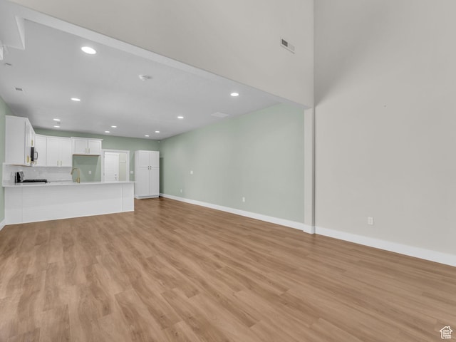 5103 W Black Twig Dr, South Jordan, UT 84009 - unfurnished living room with recessed lighting and light wood-type flooring