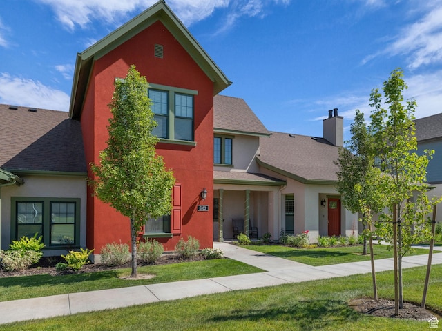 5103 W Black Twig Dr, South Jordan, UT 84009 - traditional-style house with a front yard, stucco siding, a chimney, and roof with shingles