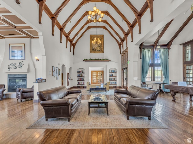 5103 W Black Twig Dr, South Jordan, UT 84009 - living room featuring a chandelier, high vaulted ceiling, hardwood / wood-style flooring, beamed ceiling, and a glass covered fireplace
