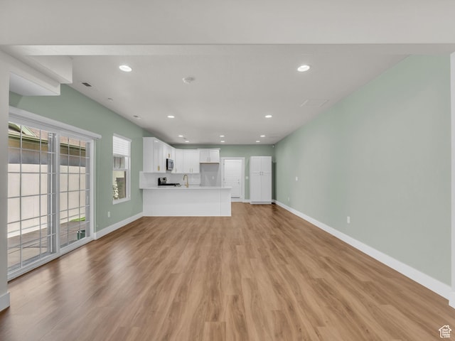5103 W Black Twig Dr, South Jordan, UT 84009 - unfurnished living room with light wood finished floors and recessed lighting
