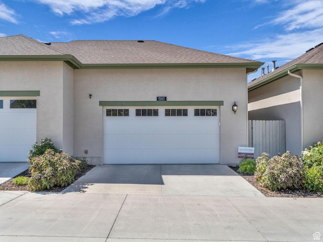 5103 W Black Twig Dr, South Jordan, UT 84009 - view of side of home with an attached garage, driveway, stucco siding, and roof with shingles