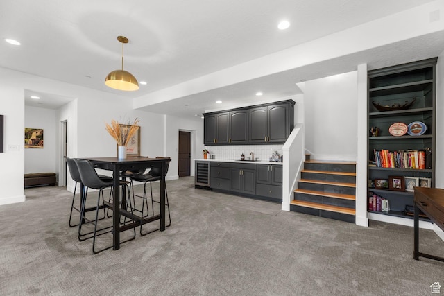 12403 Ross Creek Dr, Kamas, UT 84036 - dining area with beverage cooler, bar with sink, light carpet, recessed lighting, and stairs