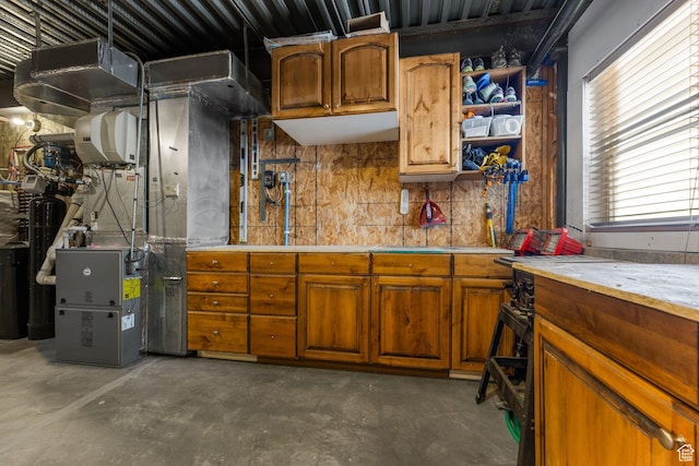 12403 Ross Creek Dr, Kamas, UT 84036 - kitchen featuring unfinished concrete flooring, light countertops, brown cabinets, and open shelves