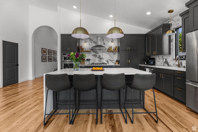 12403 Ross Creek Dr, Kamas, UT 84036 - kitchen with stainless steel appliances, wall chimney exhaust hood, light countertops, backsplash, and recessed lighting