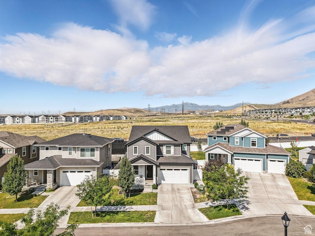 1911 N Lemongrass Dr, Saratoga Springs, UT 84045 - view of front of house with concrete driveway, a mountain view, and a residential view