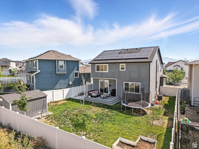 1911 N Lemongrass Dr, Saratoga Springs, UT 84045 - rear view of property with solar panels, a fenced backyard, a residential view, and a storage unit