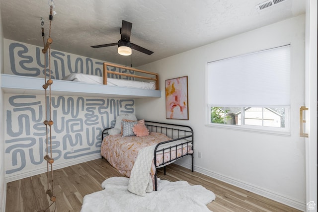 1012 N Cambria Dr, North Salt Lake, UT 84054 - bedroom featuring wood finished floors, a textured ceiling, and ceiling fan