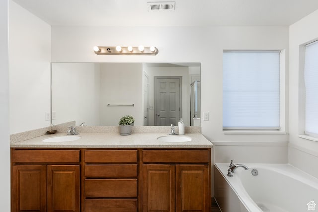 1012 N Cambria Dr, North Salt Lake, UT 84054 - bathroom featuring double vanity and a garden tub