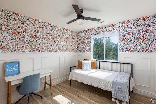 1012 N Cambria Dr, North Salt Lake, UT 84054 - bedroom with wallpapered walls, a wainscoted wall, wood finished floors, a decorative wall, and a desk