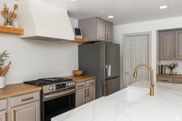 1012 N Cambria Dr, North Salt Lake, UT 84054 - kitchen with appliances with stainless steel finishes, extractor fan, gray cabinetry, tasteful backsplash, and recessed lighting