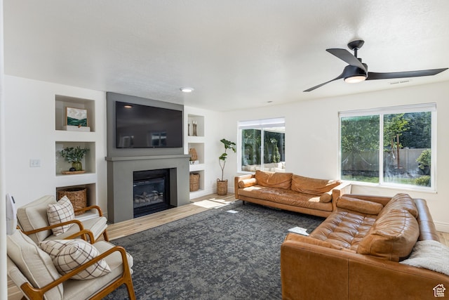 1012 N Cambria Dr, North Salt Lake, UT 84054 - living room with a ceiling fan, a glass covered fireplace, and built in features