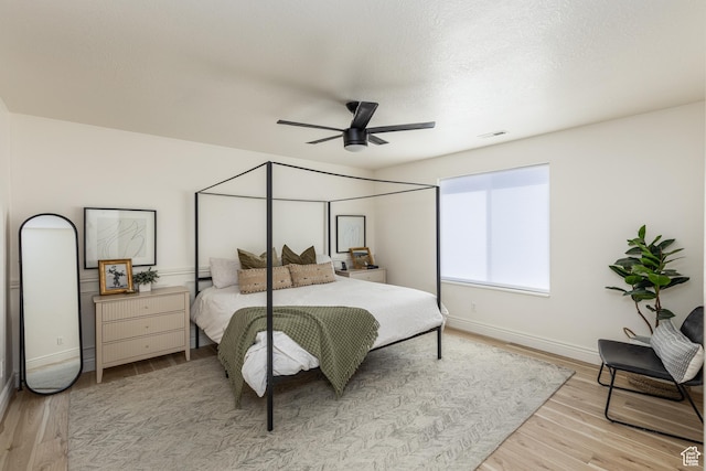 1012 N Cambria Dr, North Salt Lake, UT 84054 - bedroom with light wood-style flooring, ceiling fan, and a textured ceiling