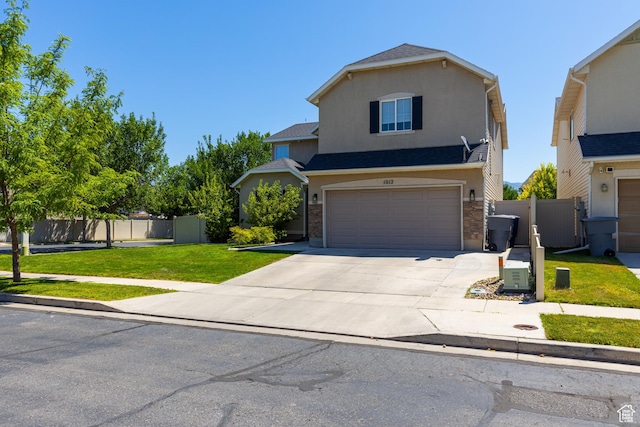 1012 N Cambria Dr, North Salt Lake, UT 84054 - traditional-style house featuring an attached garage, concrete driveway, stucco siding, and a gate