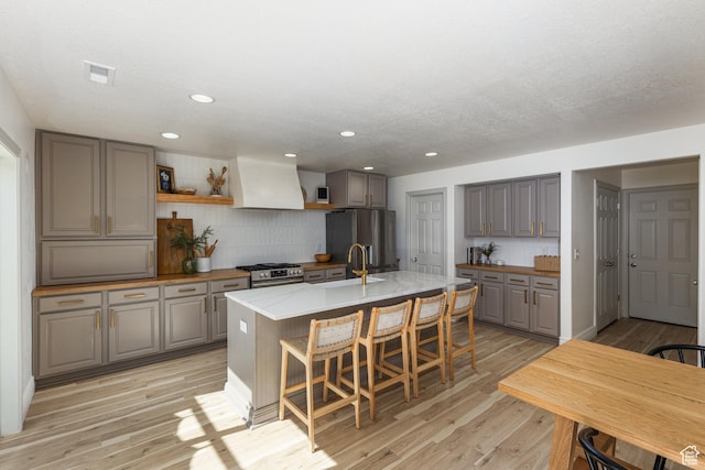 1012 N Cambria Dr, North Salt Lake, UT 84054 - kitchen featuring custom range hood, stainless steel appliances, gray cabinets, open shelves, and recessed lighting