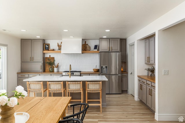 1012 N Cambria Dr, North Salt Lake, UT 84054 - kitchen featuring stainless steel fridge, open shelves, gray cabinetry, premium range hood, and recessed lighting