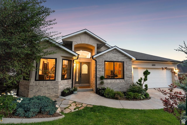 1044 S Terrace Dr E, Bountiful, UT 84010 - view of front of home with an attached garage, driveway, stone siding, and stucco siding