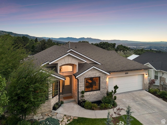 1044 S Terrace Dr E, Bountiful, UT 84010 - view of front of house with a garage, stone siding, driveway, and a mountain view