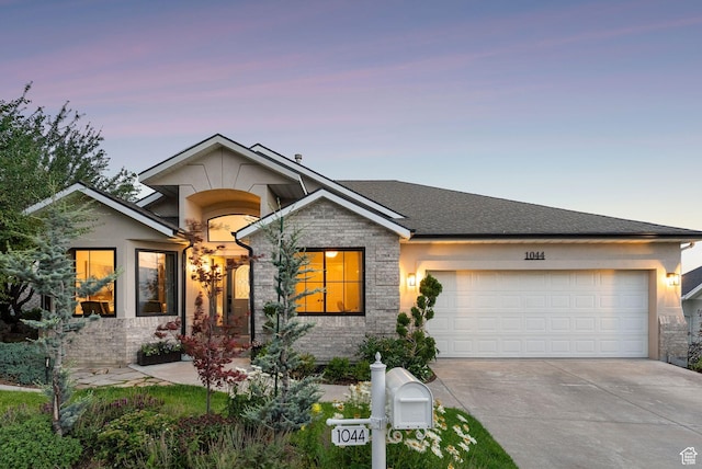 1044 S Terrace Dr E, Bountiful, UT 84010 - view of front of house with concrete driveway, an attached garage, stone siding, and stucco siding