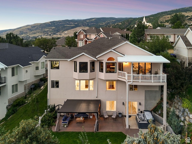 1044 S Terrace Dr E, Bountiful, UT 84010 - back of property at dusk featuring a balcony, stucco siding, and a mountain view