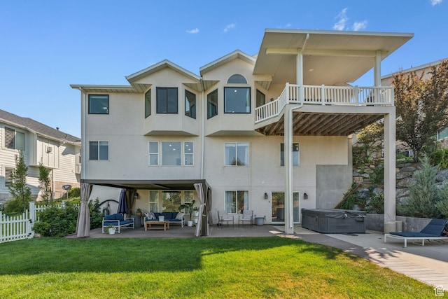 1044 S Terrace Dr E, Bountiful, UT 84010 - rear view of house with a hot tub, an outdoor living space, a patio area, stucco siding, and a balcony