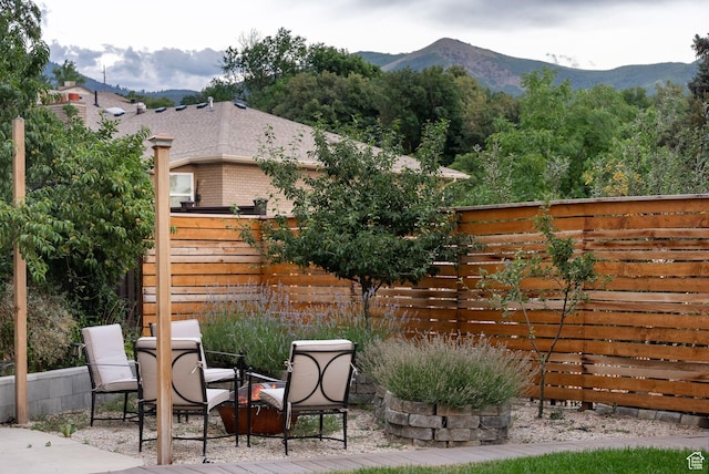 1044 S Terrace Dr E, Bountiful, UT 84010 - fenced backyard featuring a patio, a mountain view, and outdoor dining space