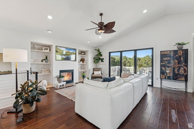 1044 S Terrace Dr E, Bountiful, UT 84010 - living room featuring ceiling fan, vaulted ceiling, a glass covered fireplace, built in shelves, and dark wood finished floors