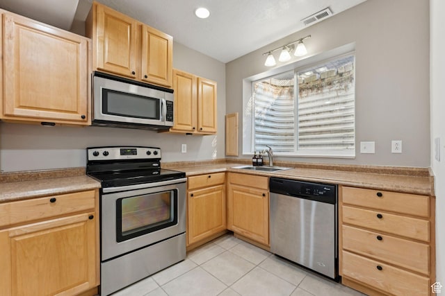 1044 S Terrace Dr E, Bountiful, UT 84010 - kitchen with stainless steel appliances, light brown cabinetry, light tile patterned floors, and light countertops