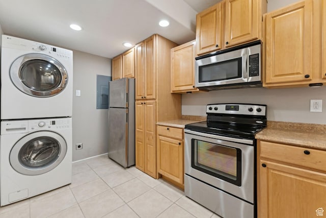 1044 S Terrace Dr E, Bountiful, UT 84010 - kitchen with stainless steel appliances, stacked washer / dryer, recessed lighting, light tile patterned floors, and light brown cabinetry